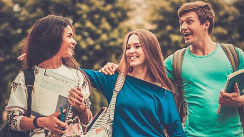 Group of multi ethnic students walking in a city