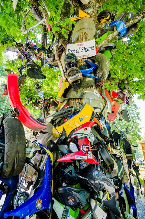 Zoonar GmbH/Alamy A memorial of smashed helmets and motorcycle parts sits by the road (Credit: Zoonar GmbH/Alamy)