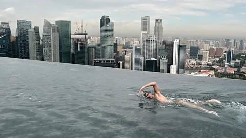 Getty Images Australian Christian Sprenger swims in the rooftop pool at the Marina Bay Sands resort hotel (Credit: Getty Images)
