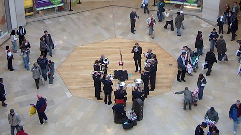 Focus image: a brass band playing Christmas carols in a shopping centre