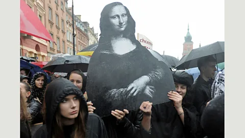 AP Photo/Alik Keplicz Women in Warsaw, Poland carry a reproduction of the Mona Lisa during a nationwide ‘Black Monday’ strike to protest a proposed total ban on abortion (Credit: AP Photo/Alik Keplicz)