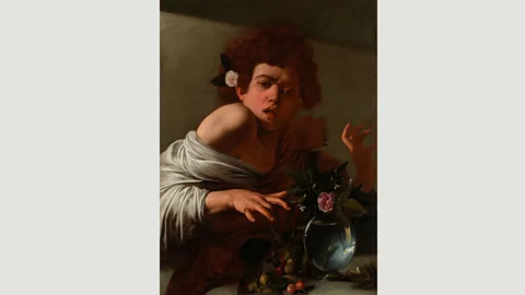 The National Gallery, London A rose and sprig of jasmine inside a glass vase beside some cherries are placed prominently in the foreground in Boy Bitten by a Lizard (Credit: The National Gallery, London)