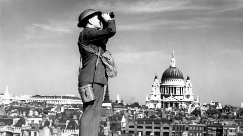 Getty Images An air-raid warden watches the sky in London during the Blitz – at that time St Paul’s cathedral towered over everything else in the City (Credit: Getty Images)