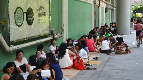 Chris Dwyer These women often congregate on Sunday, their day off (Credit: Chris Dwyer)