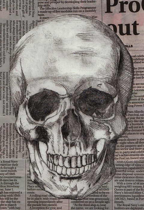 Student etching of a skull printed onto a newspaper background