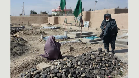 Seamus Murphy/Panos Pictures The parents of the late poet Rahila Muska are photographed next to her grave in Gereshk: they denied that their daughter wrote poetry (Credit: Seamus Murphy/Panos Pictures)