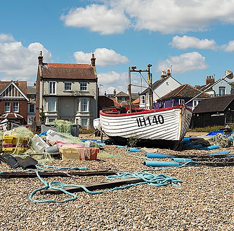 Photograph of a fishing boat on a beach. 