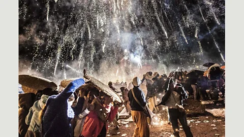 Aung Thu/AFP/Getty Images People protect themselves from fireworks that ignited too early during the Tazaungdaing Lighting Festival at Taunggyi in Myanmar (Credit: Aung Thu/AFP/Getty Images)