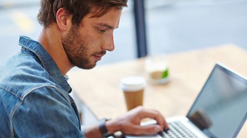 A screenwriter typing up a script at a laptop