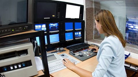 A film editor cutting a programme in an edit suite