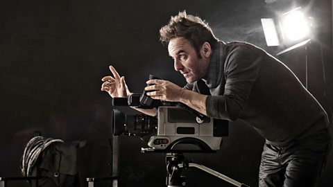 A director of photography checking a shot before filming