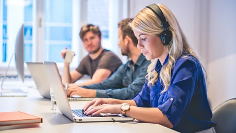 Getty Images Headphones have been adopted in place of office "do not disturb" signs (Credit: Getty Images)