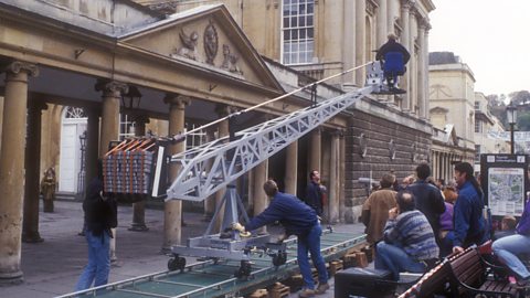 A film crew using a crane to get high angle shots