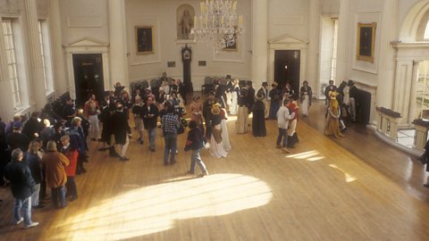 Behind the scenes shot of a period drame with light streaming in the windows
