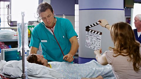 An actor from Casualty wearing a nurses uniform