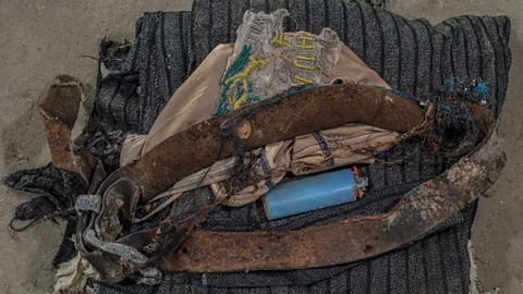 Andrew Testa/Panos The belongings of the dead are laid at the foot of each table holding a skeleton at the Krajina Identification Project in Sanski Most (Credit: Andrew Testa/Panos)