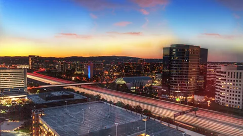 Alamy Sunrise over a highway in Irvine, California. The city was a draw for Mika Sun, who looked for a safe community with good healthcare and a pristine environment (Credit: Alamy)