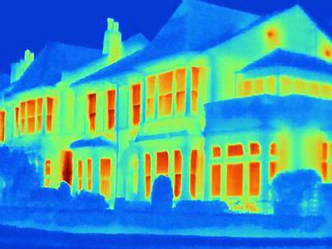 A terraced house tinted with a blue hue. The doors and windows have a red hue which signifies escaping heat.