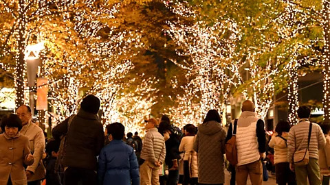 Getty Images People walk beneath Christmas decorations in the Marunouchi shopping district of Tokyo on December 2, 2016 (Credit: Getty Images)