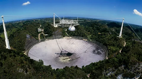 SPL Signals detected by the giant Arecibo radio telescope in Puerto Rico have helped scientists hone in on the source of a fast radio burst (Credit: SPL)