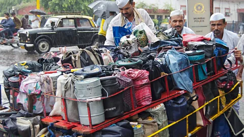 Getty Images Lunchboxes coming from all over the city are loaded onto bicycles and handcarts for the final leg of their journey (Credit: Getty Images)