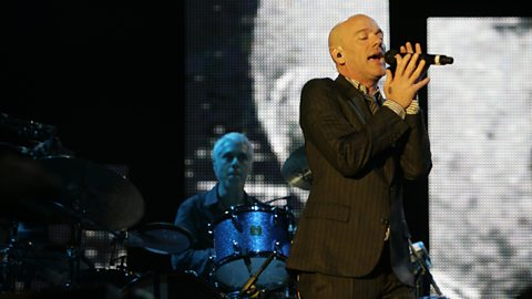 Michael Stipe performing in concert with R.E.M.