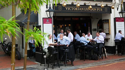 Alamy City workers drinking at a British style pub in Boat Quay, Singapore (Credit: Alamy)