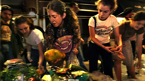 Getty Images A growing number of people go dumpster diving, taking discarded food from bins outside restaurants and supermarkets (Credit: Getty Images)