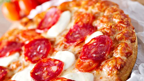 iStock Pizza started thin and simply flavoured in Italy, but in America they're bigger and boast many more ingredients (Credit: iStock)