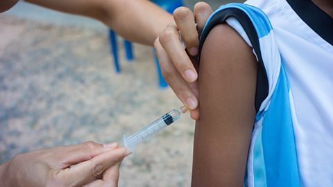 A patient receiving an injection from a doctor