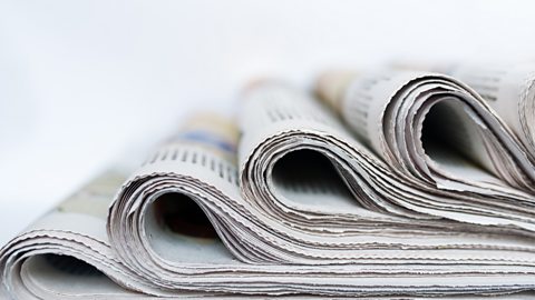 Close-up of newspapers in a stack, ready for distribution