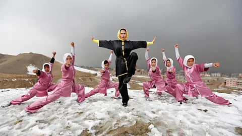 Reuters/Mohammad Ismail Sima Azimi, 20, a trainer at a Shaolin Wushu club, poses with her students after an exercise on a hilltop west of Kabul (Credit: Reuters/Mohammad Ismail)