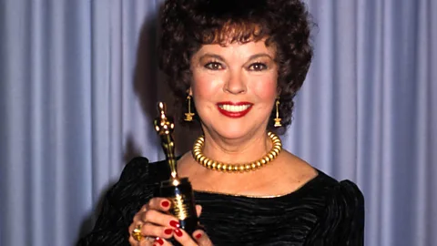 Alamy The Academy Juvenile Award, held by Shirley Temple in 1984, was half the size of a regular Oscar statuette and was handed out to 12 performers over 26 years (Credit: Alamy)
