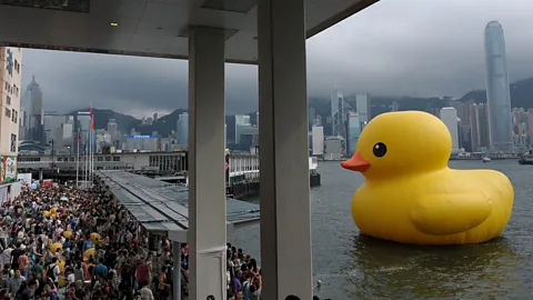 Getty Images Large works – like this giant duck by Dutch artist Florentijn Hofman – are an example of the art drawing large crowds in Hong Kong (Credit: Getty Images)