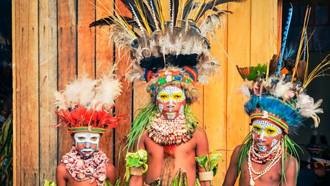 Three native children with face paint and traditional dress, Papua New Guinea