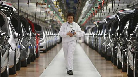 Getty Images Finished cars on the assembly line at a Volkswagen car factory in Germany (Credit: Getty Images)