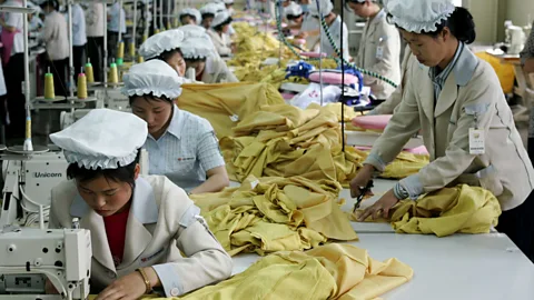 Getty Images North Korean women work with dexterity at a South Korean textile company (Credit: Getty Images)