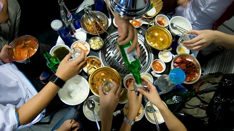 Alamy A group of friends gathers for a barbecue at a restaurant in Seoul (Credit: Alamy)