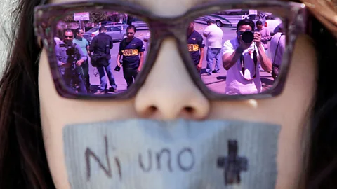 Reuters/Jose Luis Gonzalez Journalists are reflected in the sunglasses of a woman at a protest against the murder of the Mexican journalist Miroslava Breach (Credit: Reuters/Jose Luis Gonzalez)