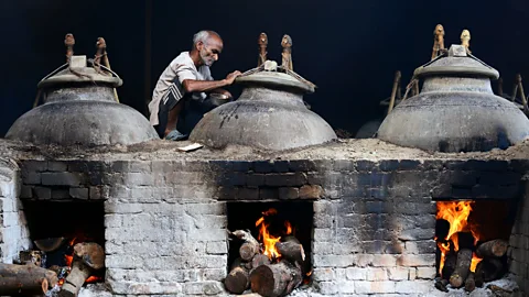 Sajjad Hussain/Stringer/Getty To release their aromas, scented items are suspended over boiling water in a sealed container (Credit: Sajjad Hussain/Stringer/Getty)