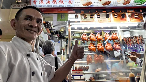 Getty Images Singaporean chef Chan Hong Meng in front of his Michelin-starred chicken rice and noodle stall (Credit: Getty Images)