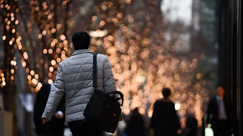 Getty Images Many Japanese work into the night, putting in 12 to 14 hour days (Credit: Getty Images)