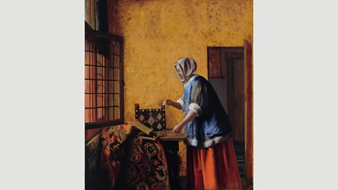 BPK, Berlin The rich clothes of the subject in Pieter de Hooch’s Woman Weighing Gold Coin suggest she is the wealthy wife of a money lender (Credit: BPK, Berlin)