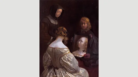 Rijksmuseum Gerard ter Borch’s Woman at a Mirror shows a wealthy lady ‘at her toilet’, a recurring motif in 17th Century Dutch art (Credit: Rijksmuseum)