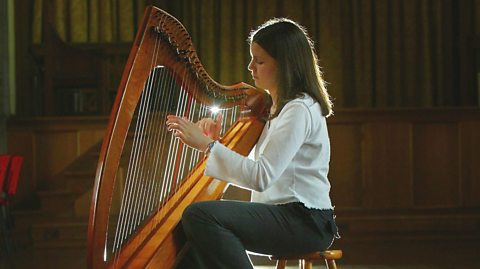 A performer playing the clarsach