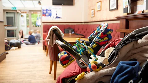 Tom Watkins Strollers line up at Tottenham’s Antwerp Arms as mothers and babies take part in a lullabies session (Credit: Tom Watkins)