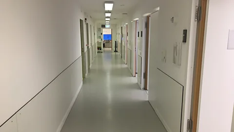 Richard Hollingham The volunteers are kept in stark, whitewashed rooms with no windows (Credit: Richard Hollingham)