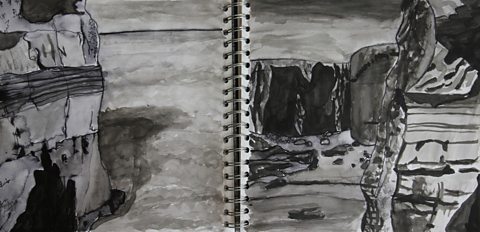 Student pen and ink wash studies of coastline on sketchbook double page