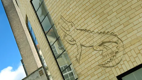 Alamy Part of the Arts and Crafts movement, Gill became quite experimental – such as carving this outline of a crocodile into the Mond Laboratory’s wall at Cambridge (Credit: Alamy)