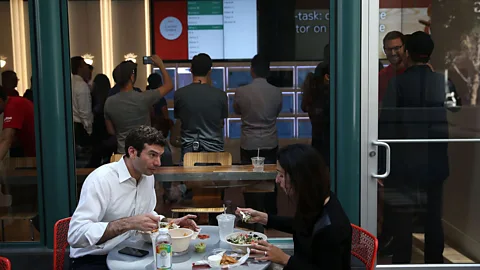 Getty Customers dine outside Eatsa, San Francisco's first fully automated restaurant in 2015 - food is picked up in 'cubbies,' no server, wait staff or cashier required. (Credit: Getty)